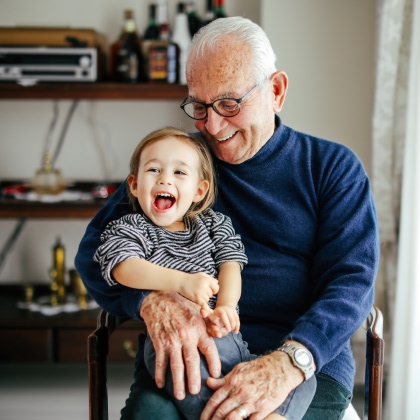 granddad holding happy toddler