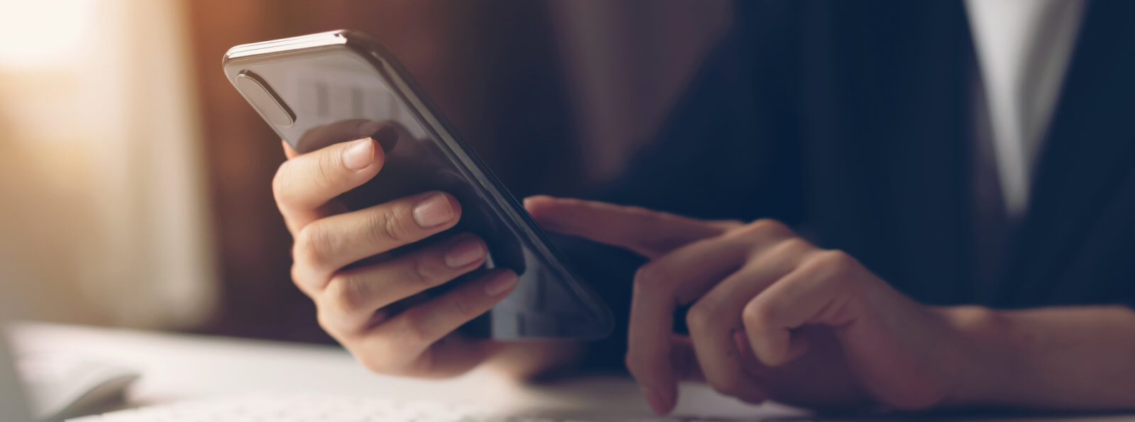close-up of hands using a smartphone