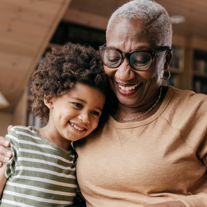 mature woman hugging a young kid
