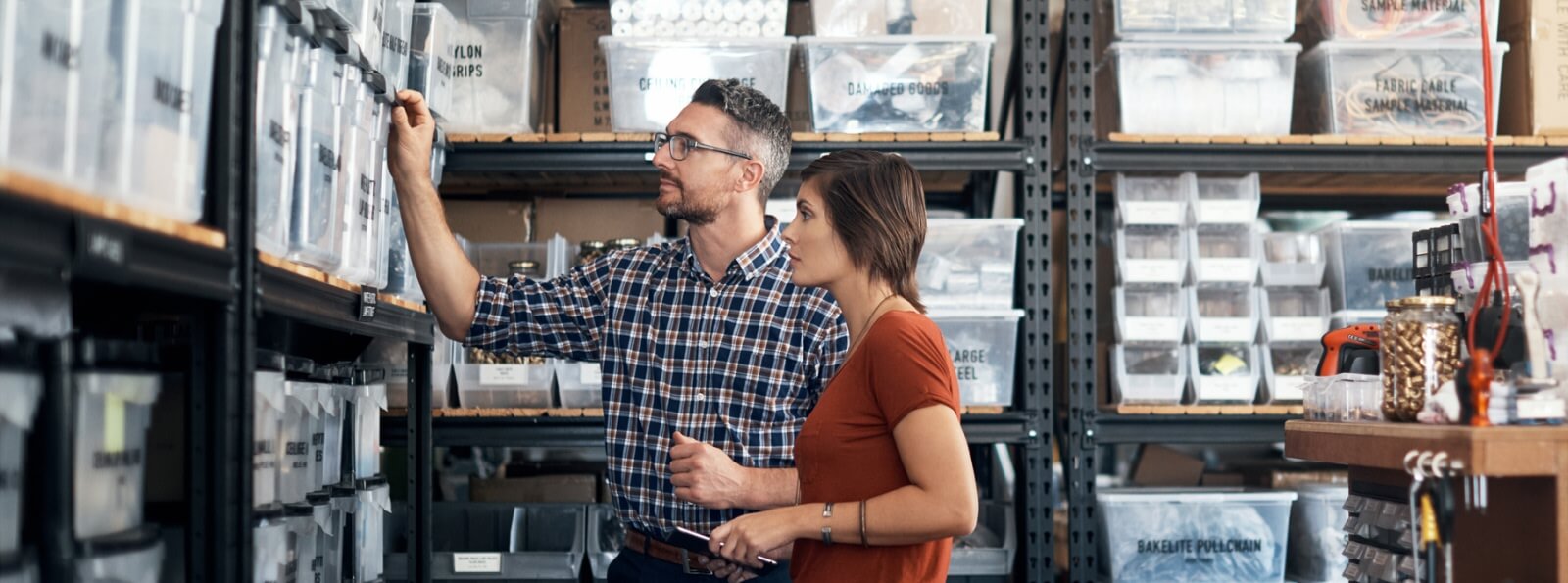 man and woman working in a warehouse